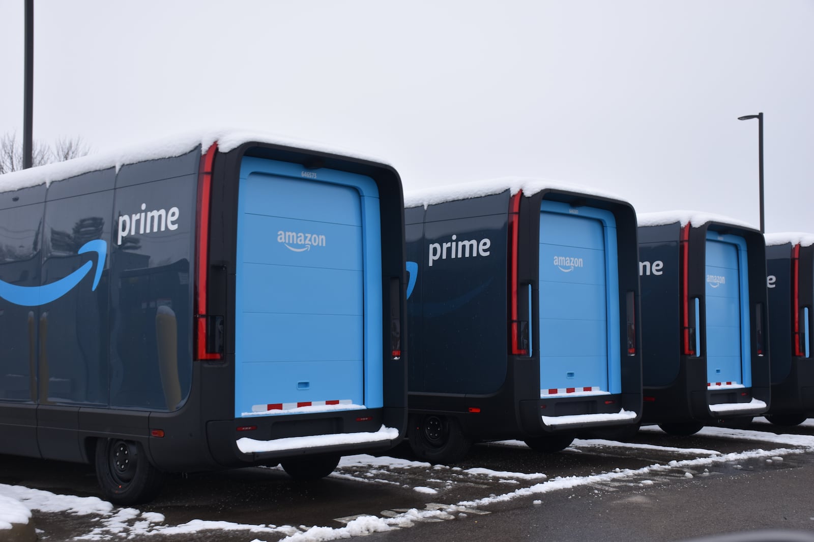 Amazon delivery trucks parked outside of a local distribution facility. CORNELIUS FROLIK / STAFF