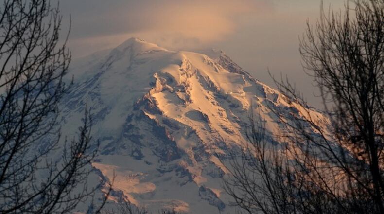 Mount Rainier at dusk in January 2012. Interior Secretary Ryan Zinke says he'll ease the impact of potentially huge National Park Service budget cuts by shifting more resources to the "front line," but offers little detail. (Ellen M. Banner/Seattle Times/TNS)