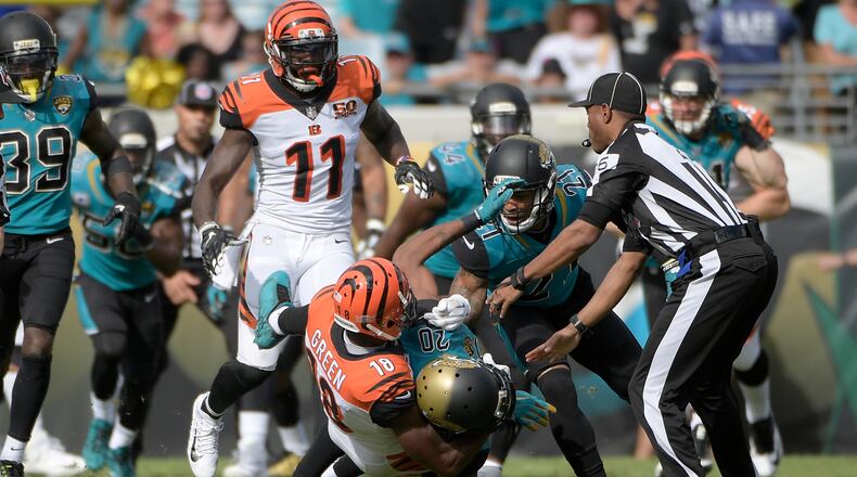 Cincinnati Bengals wide receiver A.J. Green (18) takes down Jacksonville Jaguars cornerback Jalen Ramsey (20) during a fight in the first half of an NFL football game Sunday, Nov. 5, 2017, in Jacksonville, Fla. (AP Photo/Phelan M. Ebenhack)