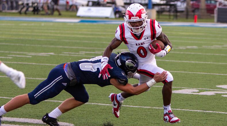 Trotwood-Madison running back Michael Smith tries to get past a Fairmont defender Friday night. Smith rushed for 134 yards and two touchdowns. Jeff Gilbert/CONTRIBUTED