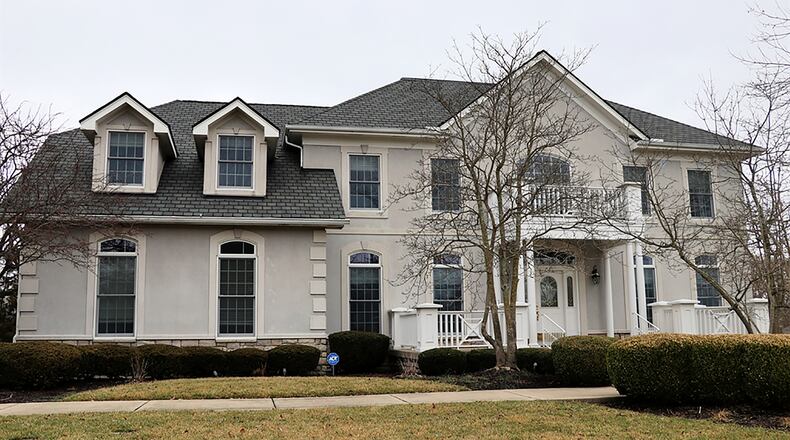 The 6-bedroom home has about 6,850 sq. ft. of living space. The property has an oversized concrete driveway that leads to the side-entry, 3-car garage. CONTRIBUTED PHOTO BY KATHY TYLER
