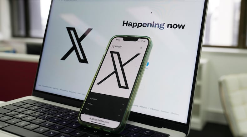 FILE - The opening page of X is displayed on a computer and phone, Oct. 16, 2023, in Sydney. (AP Photo/Rick Rycroft, File)