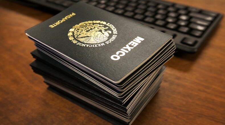 At Mexico's Consul General office in Austin, Mexican nationals wait for their passport and consul IDs to be processed. (Ralph Barrera/Austin American-Statesman/TNS)