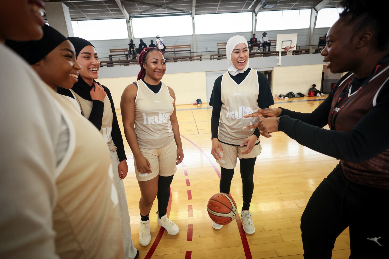 Players, some wearing headscarves, huddle during competition in Aubervilliers near Paris, Sunday, April 27, 2025. (AP Photo/Thomas Padilla)