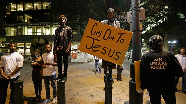 Demonstrators take to the streets of uptown during a peaceful march following Tuesday's police shooting of Keith Lamont Scott in Charlotte, N.C., Thursday, Sept. 22, 2016. (AP Photo/Gerry Broome)