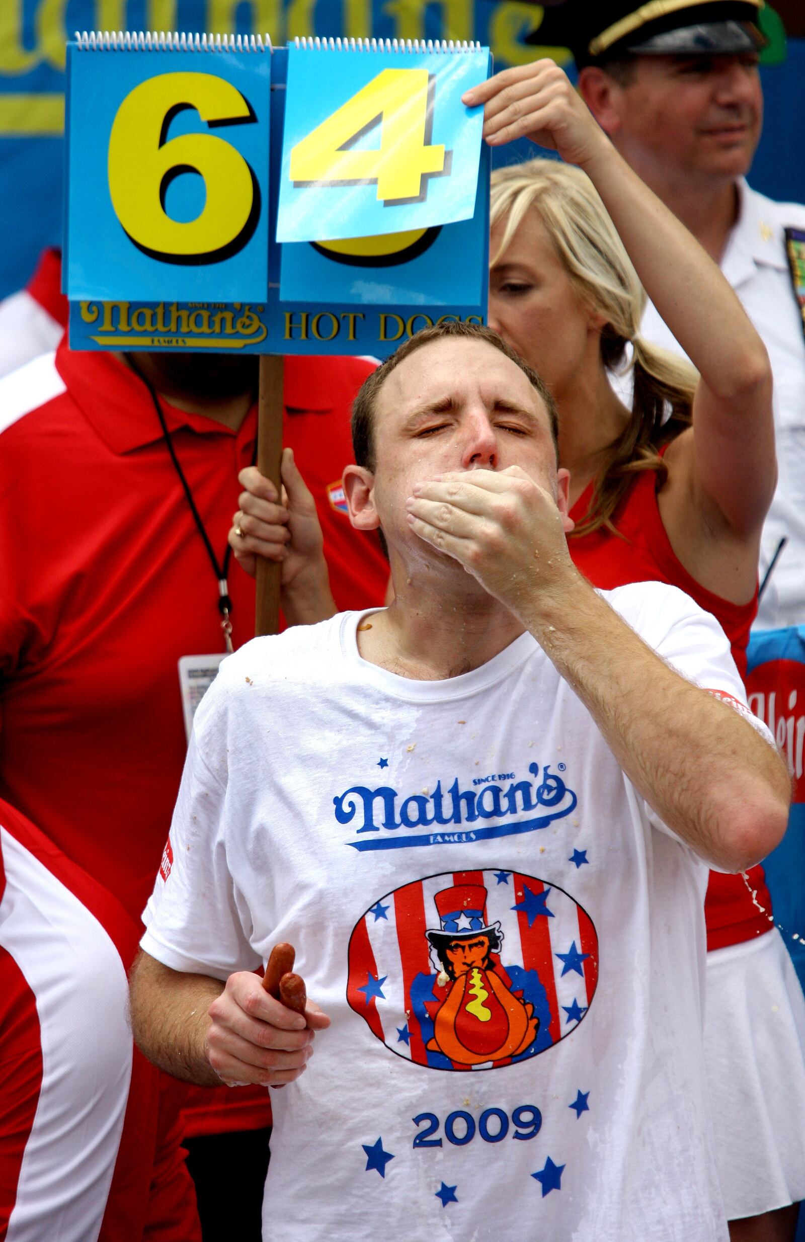 Joey Chestnut, of San Jose, Calif., defending champion of the Nathan's Famous July 4th Hot Dog Eating Contest, closes in on the world record during Coney Island's annual hot dog eating contest Saturday, July 4, 2009, in New York.  Chestnut fought off Takeru Kobayashi, of Nagano, Japan to win his third consecutive win with a world-record 68 franks. (AP Photo/Craig Ruttle)