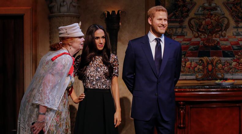NEW YORK, NY - MAY 19: Tourists pose next to wax sculptures of Meghan Markle and Prince Harry as they attend a royal wedding watch party at the Madame Tussauds wax museum on May 19, 2018 in New York, New York. (Photo by Kena Betancur/Getty Images)