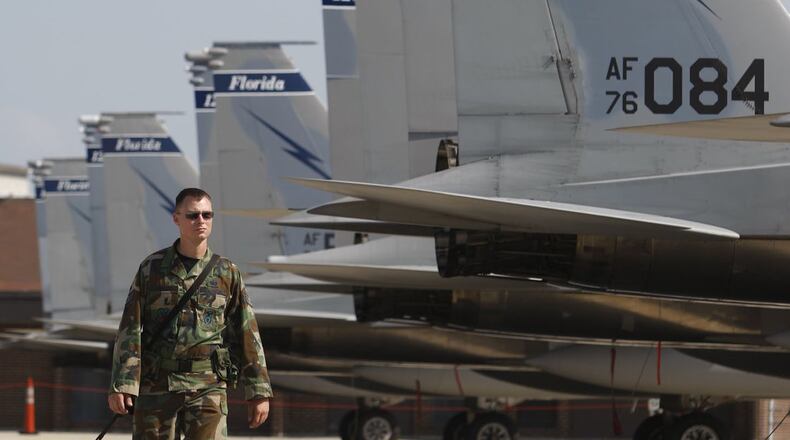 Staff Sgt. Glenn Fritch with the 125th Security Forces Squadron from the Florida Air National Guard watches over the 13 F-15 Eagles flown to Wright-Patterson Air Force Base in this 2008 file photo until Tropical Storm Hanna passes by Florida. The unit returned to Wright-Patt on Thursday as Hurricane Irma nears Florida. TY GREENLEES/STAFF FILE PHOTO