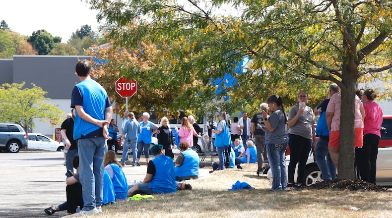 Walmart employees wait in the parking lot after the Bechtle Avenue store was evacuated due to a threat Wednesday, Sept. 18, 2024. BILL LACKEY/STAFF
