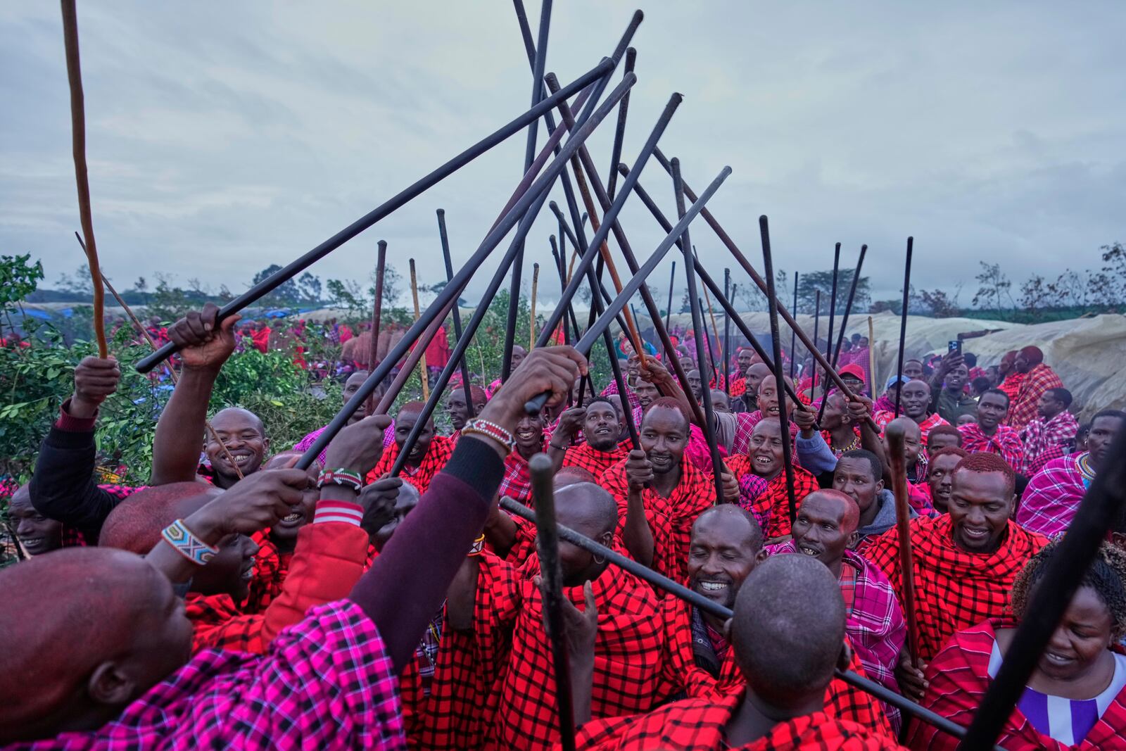 Men of the Maasai tribe perform traditional dance, during a Maasai male rite of passage, specifically the initiation of boys, marking the transition from childhood to becoming a moran (warrior) in Olaimutiai, Narok County, Kenya Wednesday, April 23, 2024. (AP Photo/Brian Inganga)