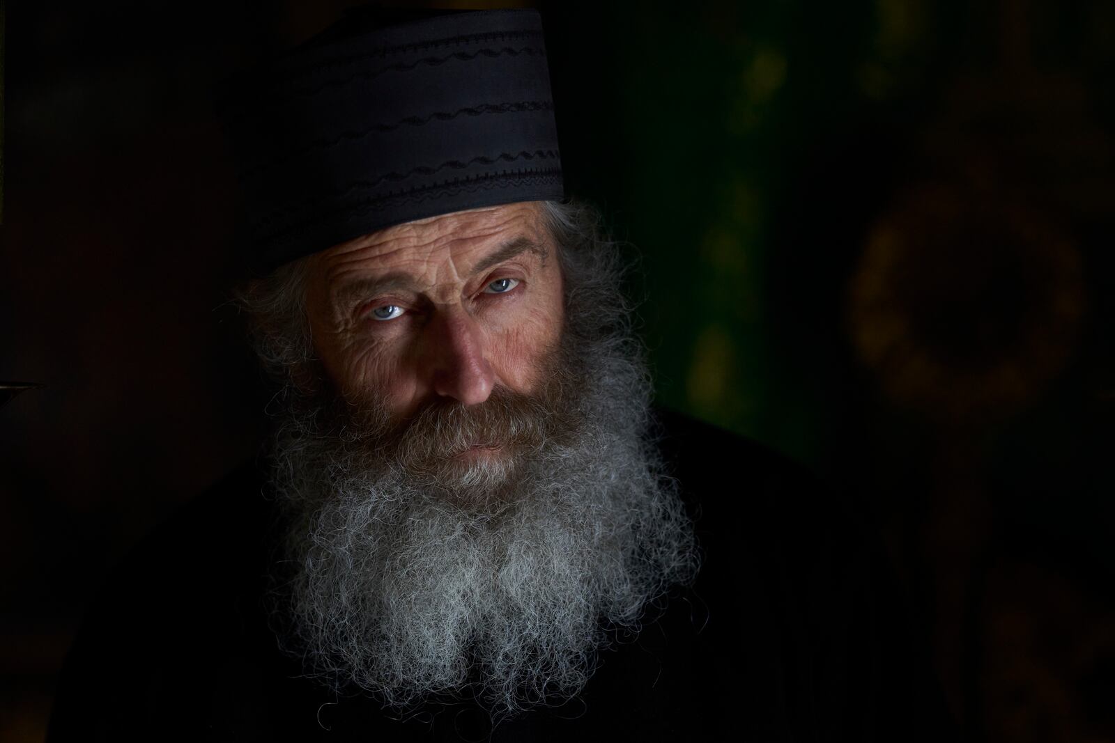 Orthodox Christian monk Father Spyridon looks on inside the chapel of the Monastery of Panagia Hozoviotissa in Amorgos island, Greece, on Thursday, March 27, 2025. (AP Photo/Petros Giannakouris)