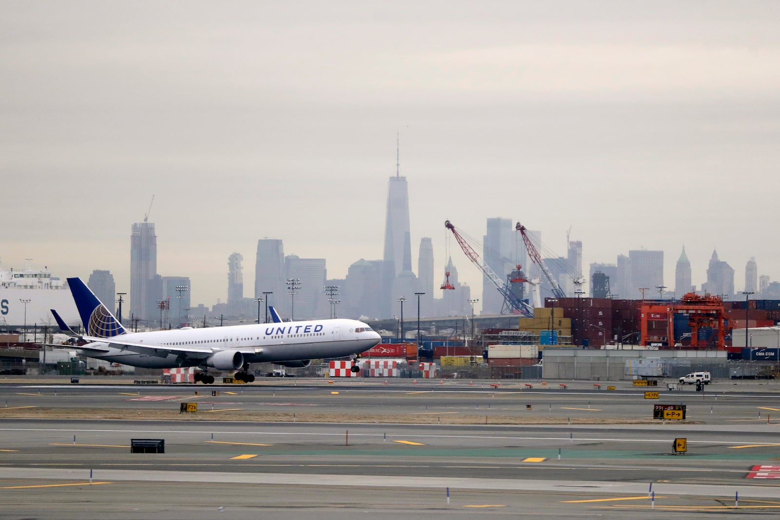 FILE - A United Airlines jet prepares touches down at Newark Liberty International Airport a day after a temporary grounding of aircraft was placed after reports of drones in the flight path, Wednesday, Jan. 23, 2019, in Newark, N.J. (AP Photo/Julio Cortez, File)
