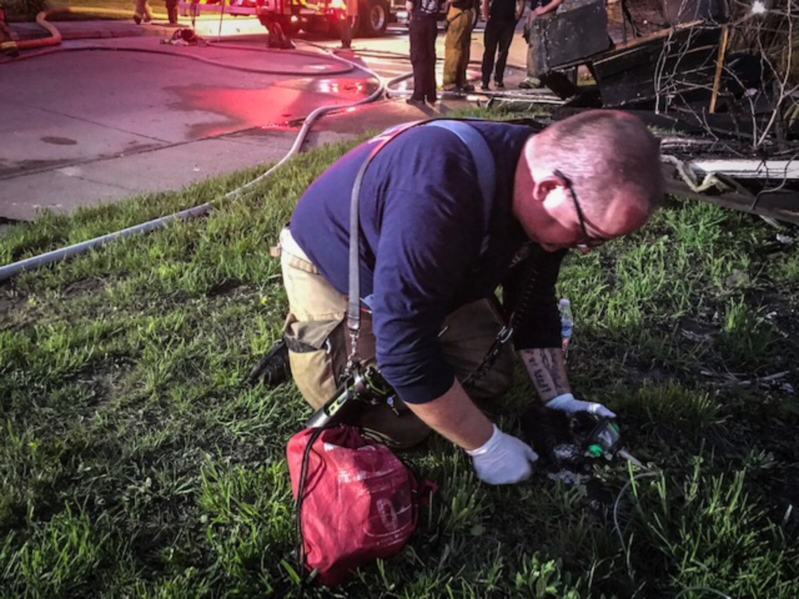 A fire fighter administers oxygen to a cat trapped in house fire.