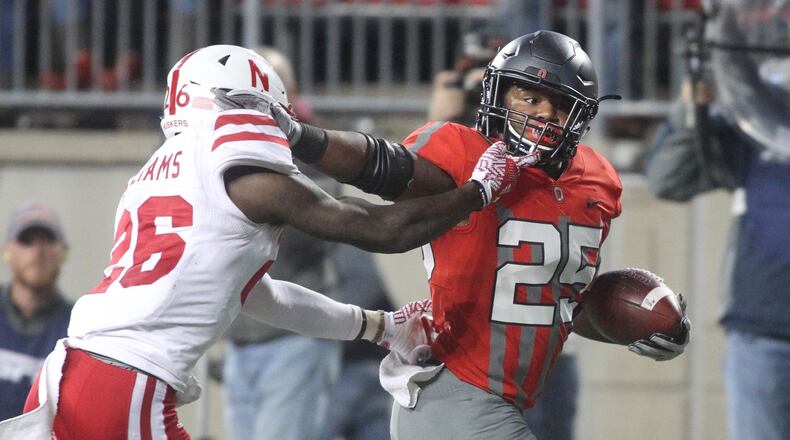 Ohio State’s Mike Weber fends off Nebraska’s Kieron Williams on a touchdown run in the first half on Saturday, Nov. 5, 2016, at Ohio Stadium in Columbus. David Jablonski/Staff