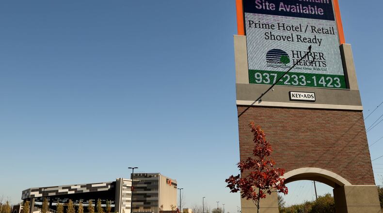 A sign at the Rose Music Center advertises to drivers on I-70 that land is available. JIM WITMER/STAFF