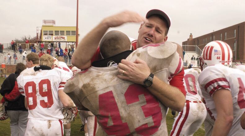 Wittenberg head coach Joe Finchams hugs linebacker Ryan Gresham following one of the biggest victories of his career, a 38-35 defeat of Hardin-Simmons in the first round of the NCAA Division III playoffs in 2001 in Abilene, Texas. Contributed photo