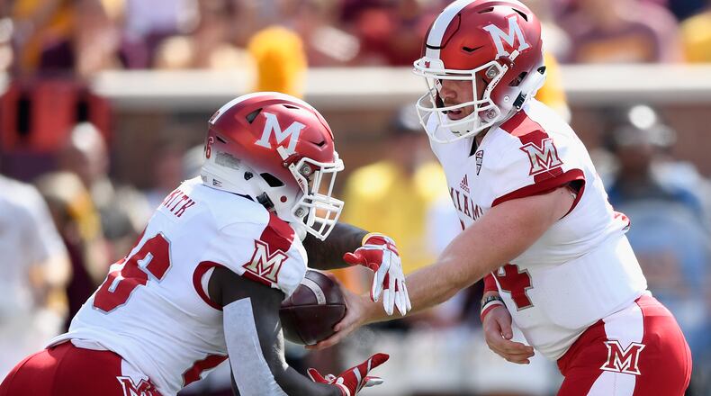 MINNEAPOLIS, MN - SEPTEMBER 15: Gus Ragland #14 of the Miami (Oh) Redhawks hands the ball to teammate Alonzo Smith #26 during the first quarter of the game on September 15, 2018 at TCF Bank Stadium in Minneapolis, Minnesota. (Photo by Hannah Foslien/Getty Images)
