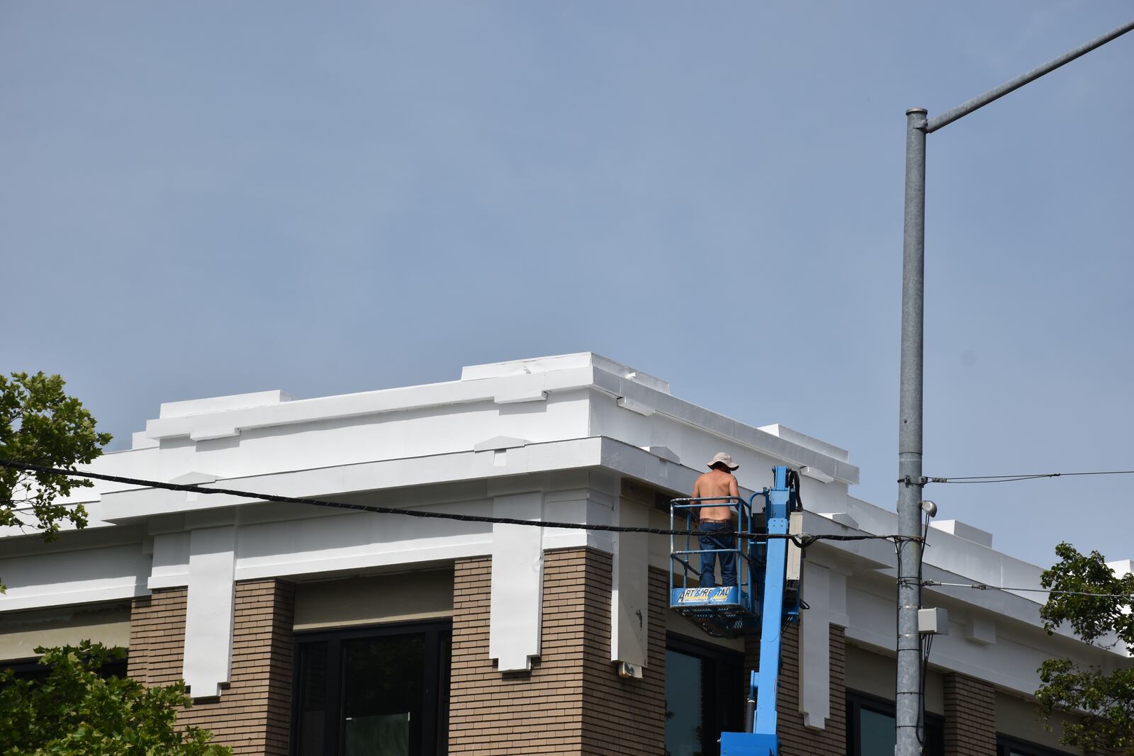 A man works on the outside of a building on the 200 block of East First Street in downtown Dayton that is home to Kaney Aerospace. CORNELIUS FROLIK / STAFF