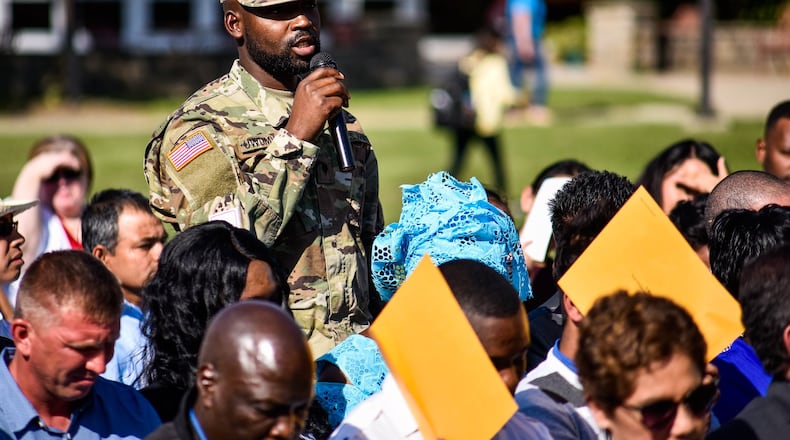 The U.S. Army soldier, Spec. Merchisedeck Uwumwaml, born in Rwanda, and lives in Dayton, stands to announce his name during a naturalization ceremony Tuesday, Sept. 17 at Miami University Regionals in Hamilton. For the second year, 99 new Americans took their oath of citizenship at the ceremony. More than 440 people have taken the oath of citizenship at Miami University Regionals in Hamilton since 2015. NICK GRAHAM/STAFF