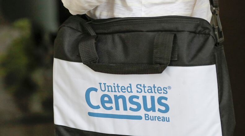 FILE - A briefcase of a census taker is seen as she knocks on the door of a residence, Aug. 11, 2020, in Winter Park, Fla. (AP Photo/John Raoux, File)