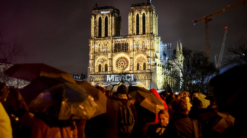 Crowds of people brave the rain to see the ceremonial reopening of Notre Dame Cathedral five years after it was gutted by fire, in Paris, Dec. 7, 2024. The second-largest group of donors to the huge fund-raising effort to restore the famous cathedral, offering an estimated $62 million to the cause, was Americans. (Dmitry Kostyukov/The New York Times)
