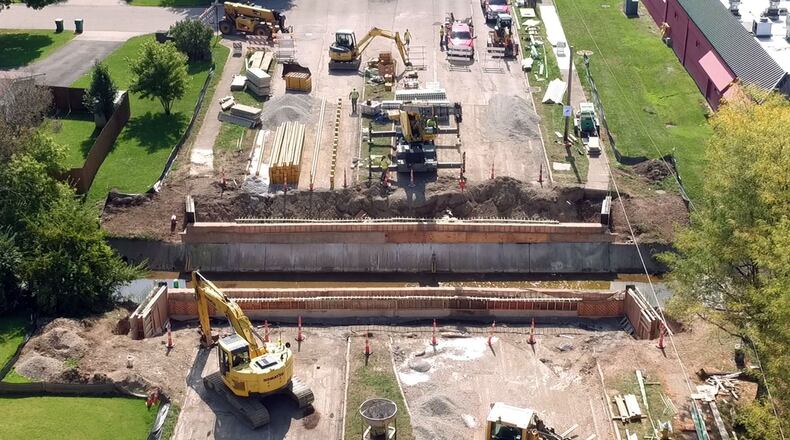 Reconstruction of the Woodman Drive Bridge is now complete. The photo here shows the earlier reconstruction of concrete slab decking to span Little Beaver Creek in Kettering. The road was closed between Stroop Road and Wilmington Pike for months. TY GREENLEES / STAFF