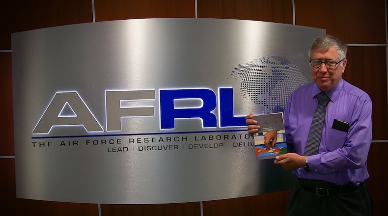 Matthew B. Cafrey Jr., an Air Force Research Laboratory plans and programs engineer, poses with his newly published textbook, “On Wargaming: How Wargames Have Shaped History and How They May Shape the Future.” (Contributed photo)