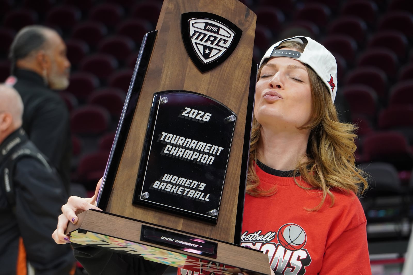 Miami assistant coach Maya Chandler poses for photos while holding the Mid-American Conference Tournament trophy on Saturday, March 14, 2026, at Rocket Arena in Cleveland. CHRIS VOGT / CONTRIBUTED