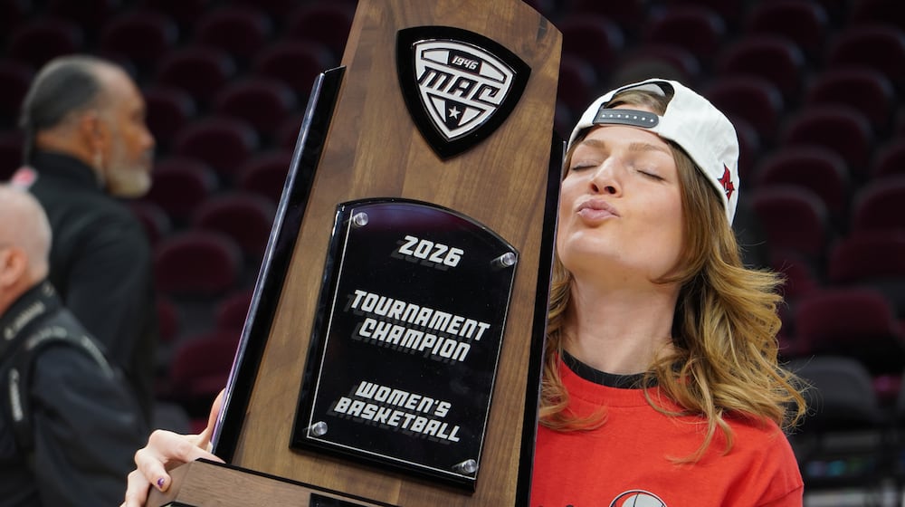 Miami assistant coach Maya Chandler poses for photos while holding the Mid-American Conference Tournament trophy on Saturday, March 14, 2026, at Rocket Arena in Cleveland. CHRIS VOGT / CONTRIBUTED