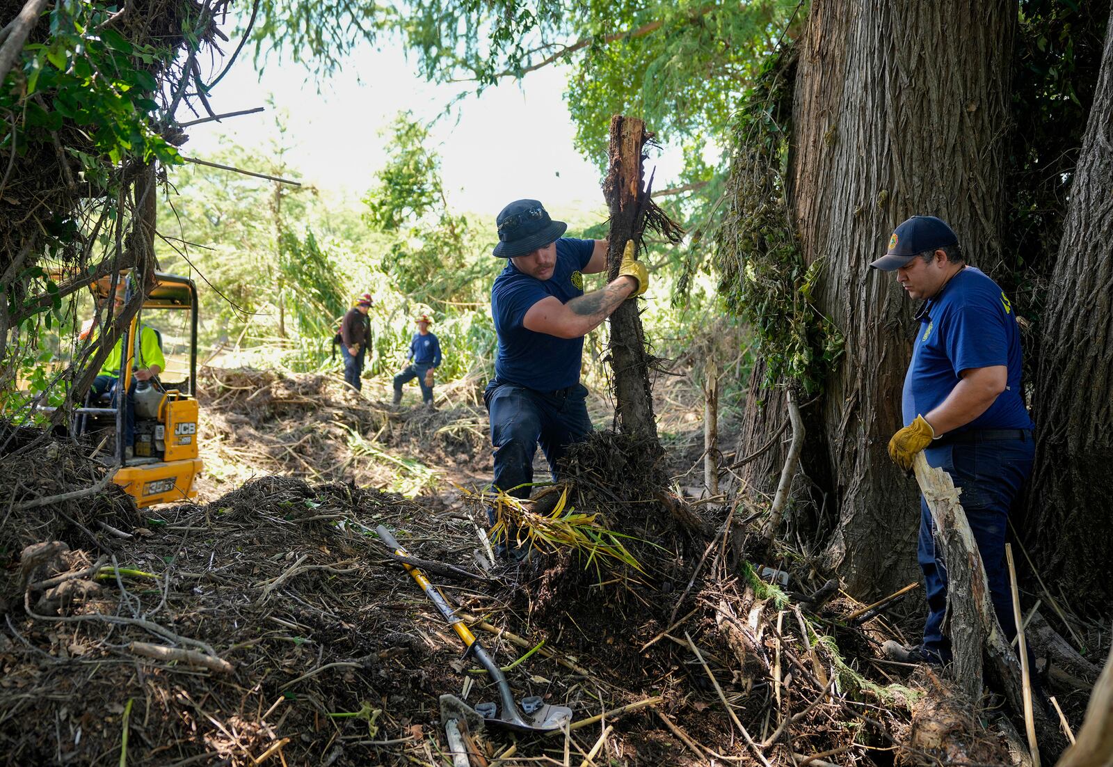 La Salle County Fire Rescue firefighters do search and rescue work on the banks of the Guadalupe River in Ingram, Texas, Tuesday, July 8, 2025, after the Fourth of July flood. (Jay Janner/Austin American-Statesman via AP)