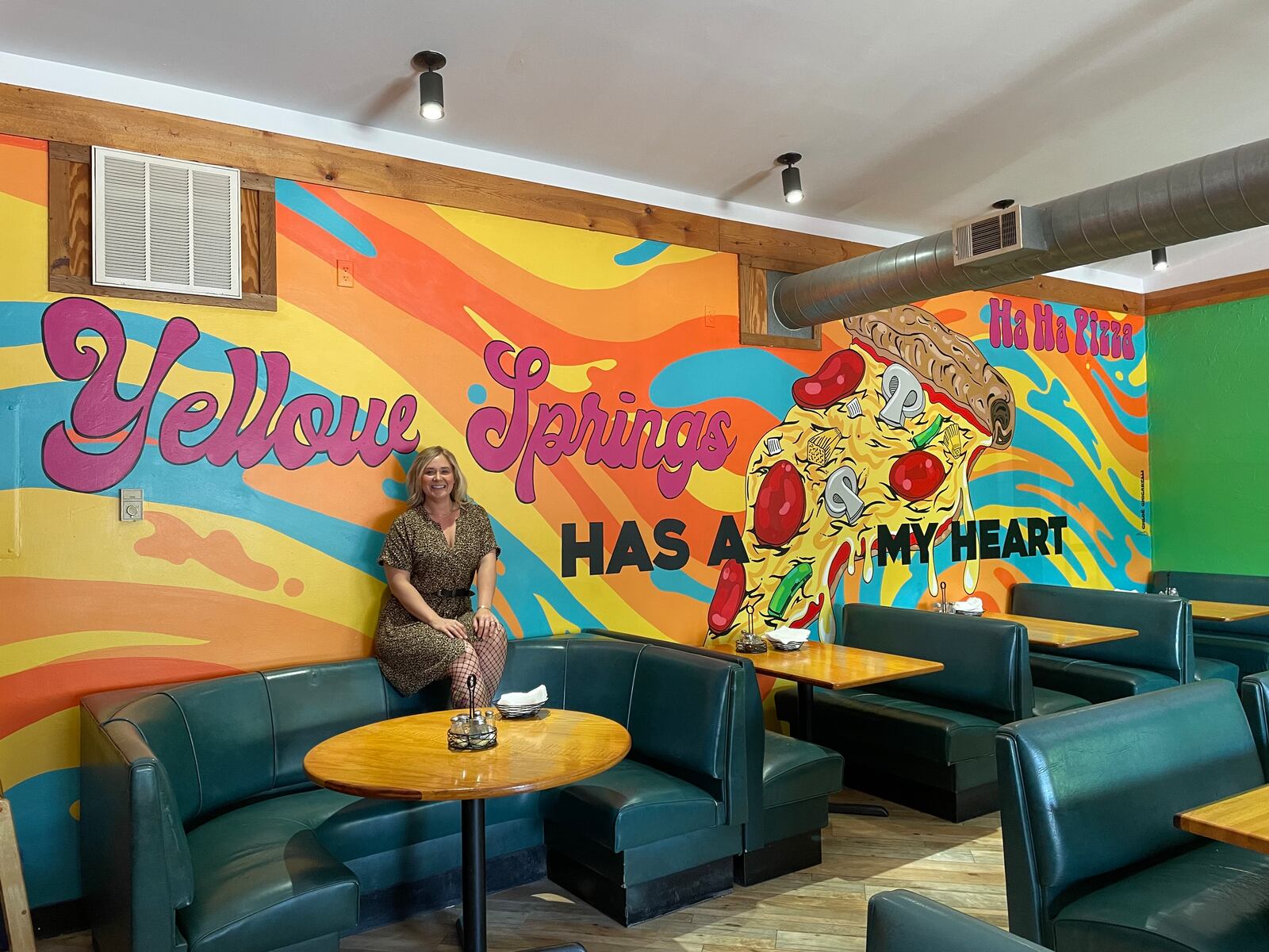Dayton-area artist Chloé Chicarelli has put her love for Yellow Springs and Ha Ha Pizza on display through a new mural inside the pizza shop. NATALIE JONES/STAFF