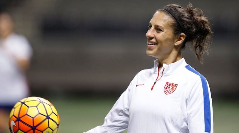 FILE - In this Dec. 15, 2015, file photo, U.S. midfielder Carli Lloyd smiles during a practice session for the team's international soccer friendly against China in New Orleans. Lloyd and defender Becky Sauerbrunn have been chosen captains of the U.S. Women's National Team. (AP Photo/Gerald Herbert, File)