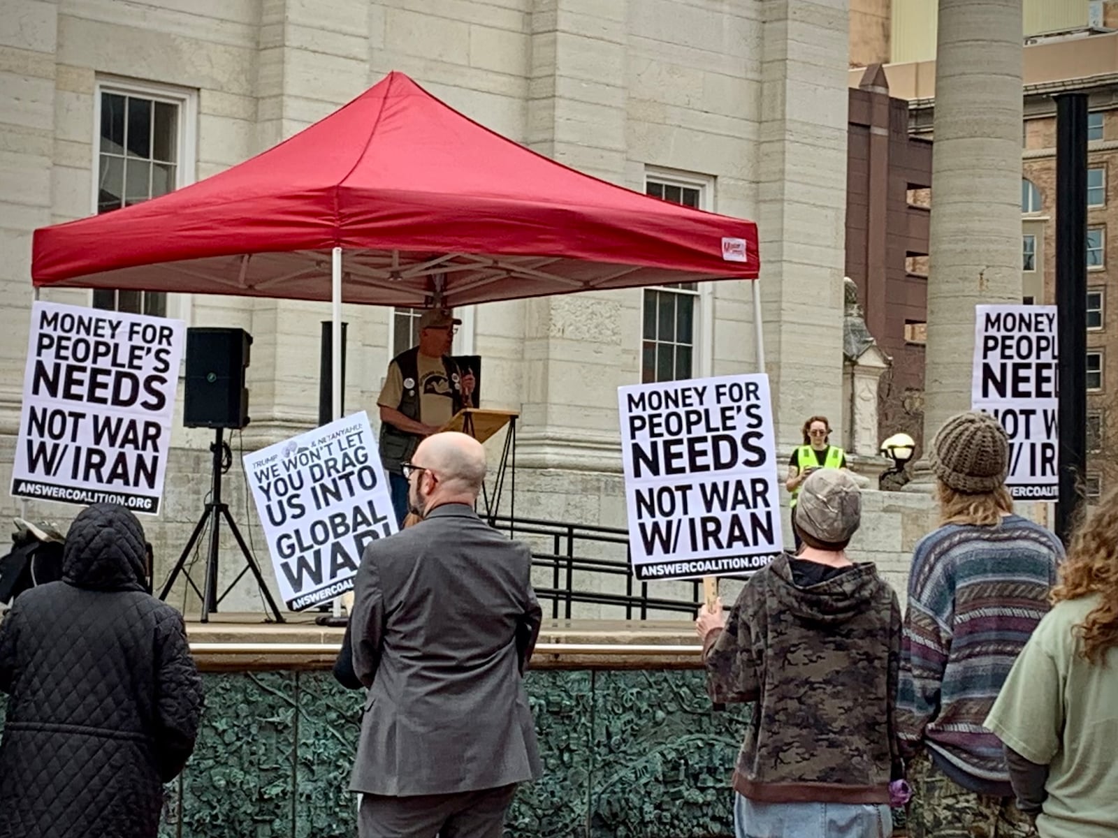 Daytonians gathered at Courthouse Square in the rain Saturday, March 7, 2026 to protest ongoing US involvement in the war with Iran. LONDON BISHOP/STAFF