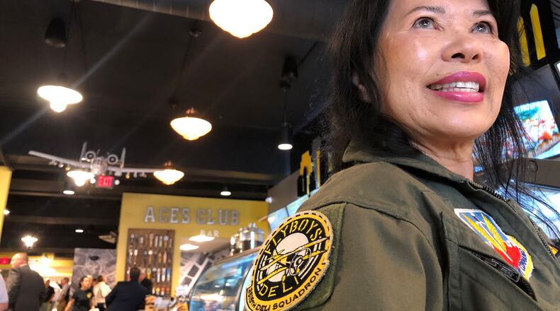 Sufong Lee wore a flight suit to the opening of the second Flyboy's location in downtown Dayton. Flyboy's moved into a space that had been vacant more than a decade. Lee is a close friend of the owners, Steve Crandall and Eunice Kim. CORNELIUS FROLIK / STAFF