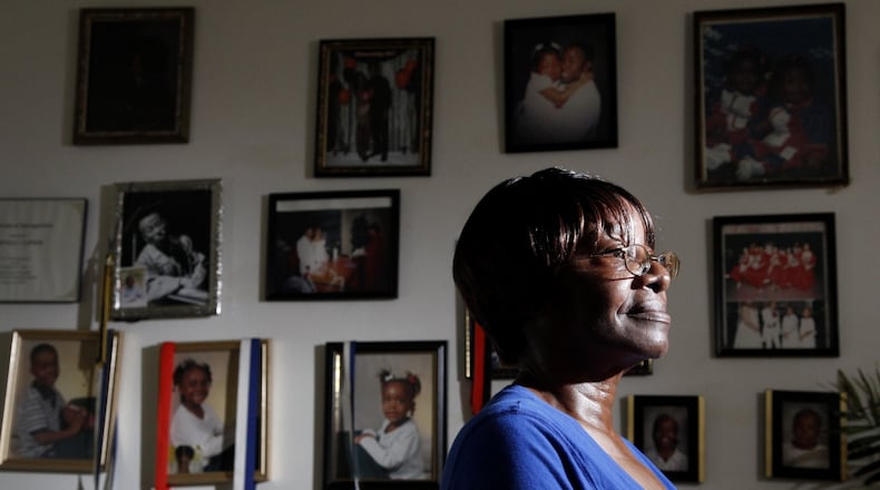 Deneva Napier keeps photographs of her grandchildren close at her Harrison Twp. apartment. Her daughter, Michelle Napier,the mother of 3 of her grandchildren, was a victim of an unsolved homicide in 2003 and another daughter, Janis Pringle, went missing the same year. LISA POWELL / STAFF