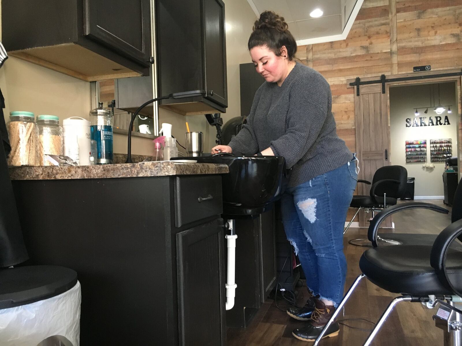 Four new businesses owned by women opened in downtown Miamisburg in the last year. Sakara salon co-owner Devon Shade washes her hands before getting started. STAFF PHOTO / HOLLY SHIVELY