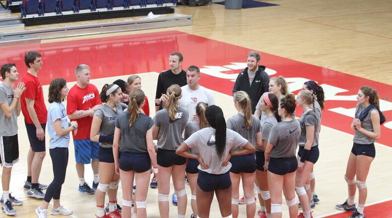 The Dayton volleyball team huddles around coach Tim Horsmon after a practice Wednesday, Nov. 30, 2016, at the Frericks Center in Dayton. David Jablonski/Staff