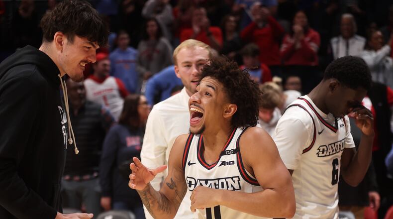 Dayton's Javon Bennett, center, celebrates after a victory against Northwestern on Saturday, Nov. 9, 2024, at UD Arena. David Jablonski/Staff