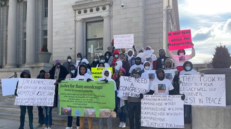 Around 30 people gathered in front of City Hall Friday to protest the ongoing genocide against the Banyamulenge people in the Democratic Republic of the Congo. CONTRIBUTED