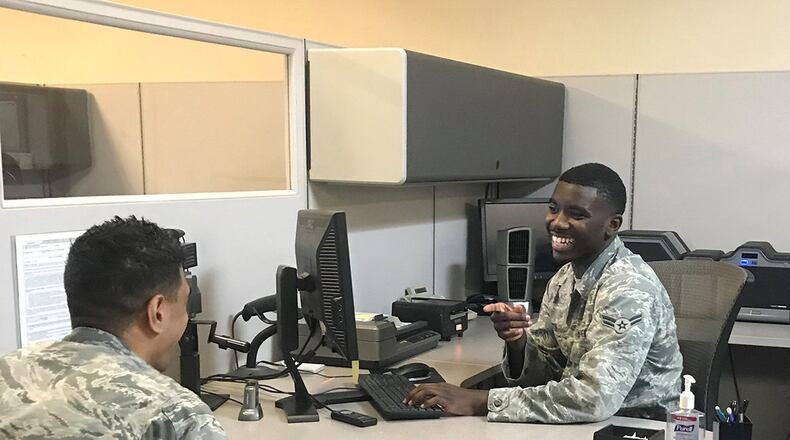 Airman First Class Melchiezedek Martin, customer support apprentice, takes a photo for an Airman’s common access card at the 88th Air Base Wing Military Personnel Flight, Wright-Patterson Air Force Base. (U.S. Air Force photo/Elizabeth Clinch)