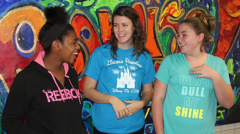 Lincoln Elementary students (left) Diondraya Beal and (right) Tearsa Gilbert discuss with (center) Megan Detrick what they want to see and do when they get to Walt Disney World. JEFF GUERINI/STAFF