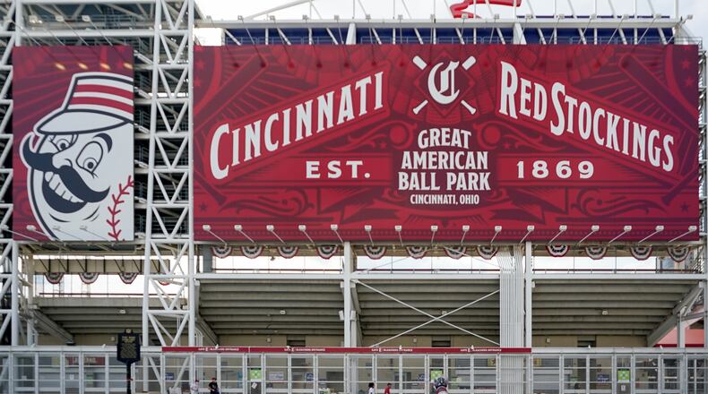 Fans stand outside of Great American Ballpark prior to a baseball game between the Cincinnati Reds and Pittsburgh Pirates, in Cincinnati, Tuesday, April.6, 2021. (AP Photo/Bryan Woolston)