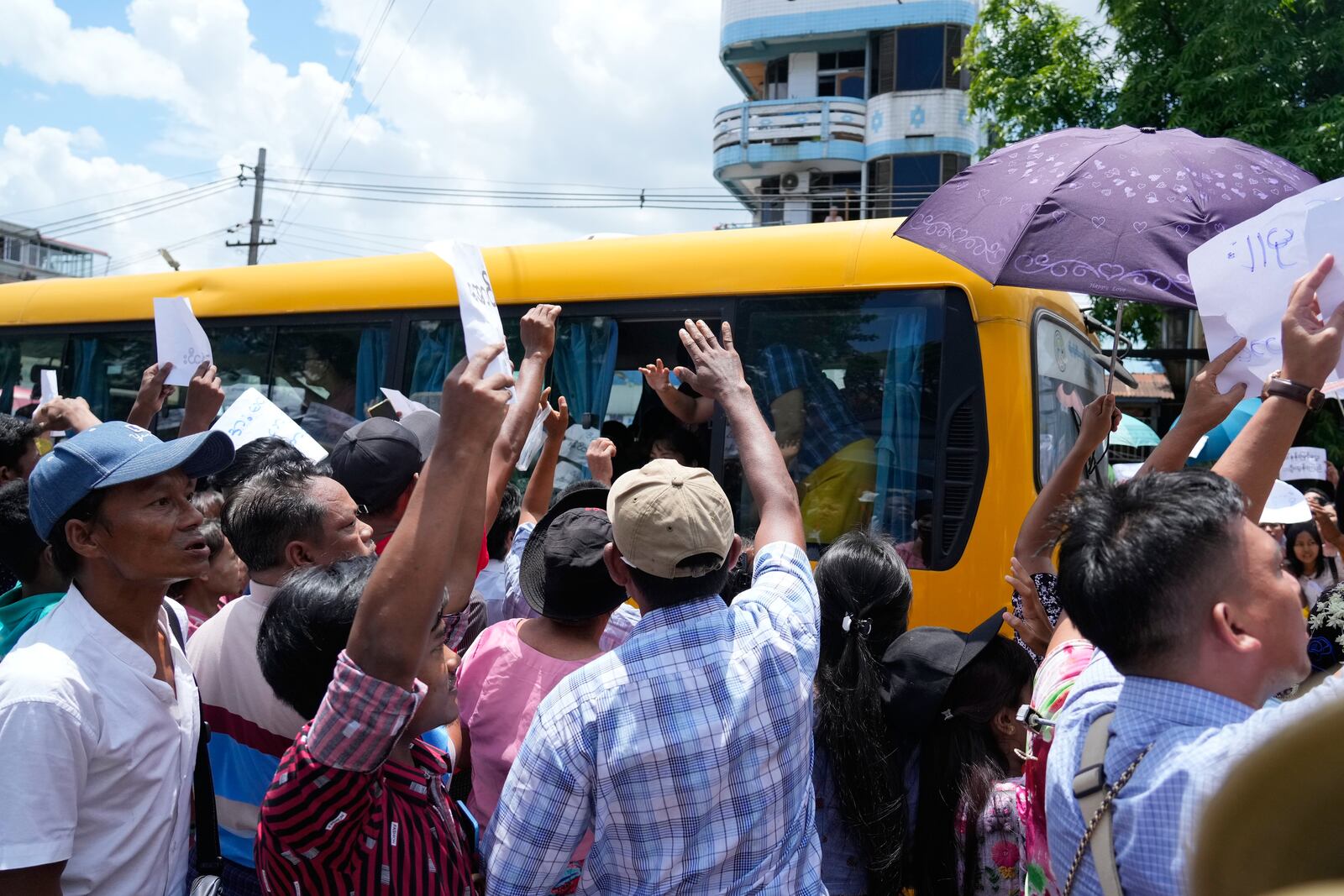 Released prisoners on a bus are welcomed by family members and colleagues outside the main gate of Insein prison as the head of Myanmar’s military government granted amnesty to thousands of prisoners to mark the country's traditional New Year Thursday, April 17, 2025, in Yangon, Myanmar. (AP Photo/Thein Zaw)