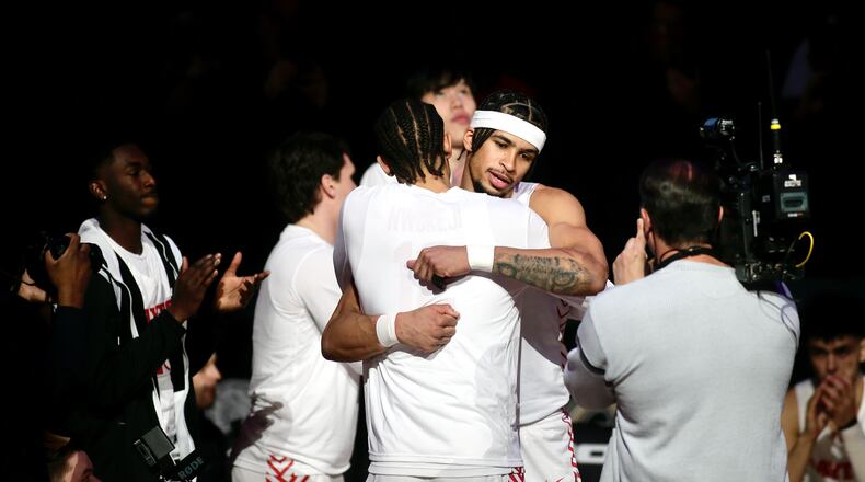 Dayton's Toumani Camara hugs Zimi Nwokeji after being introduced before a game against Fordham in the semifinals of the Atlantic 10 Conference tournament on Saturday, March 11, 2023, at the Barclays Center in Brooklyn, N.Y. David Jablonski/Staff