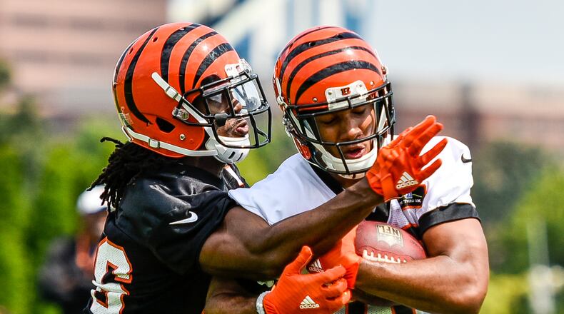 Cornerback Josh Shaw, left, tries unsuccessfully to defend a catch by wide receiver Tyler Boyd during the first day of Cincinnati Bengals Training Camp Friday, July 28 at the practice fields beside Paul Brown Stadium in Cincinnati. NICK GRAHAM/STAFF
