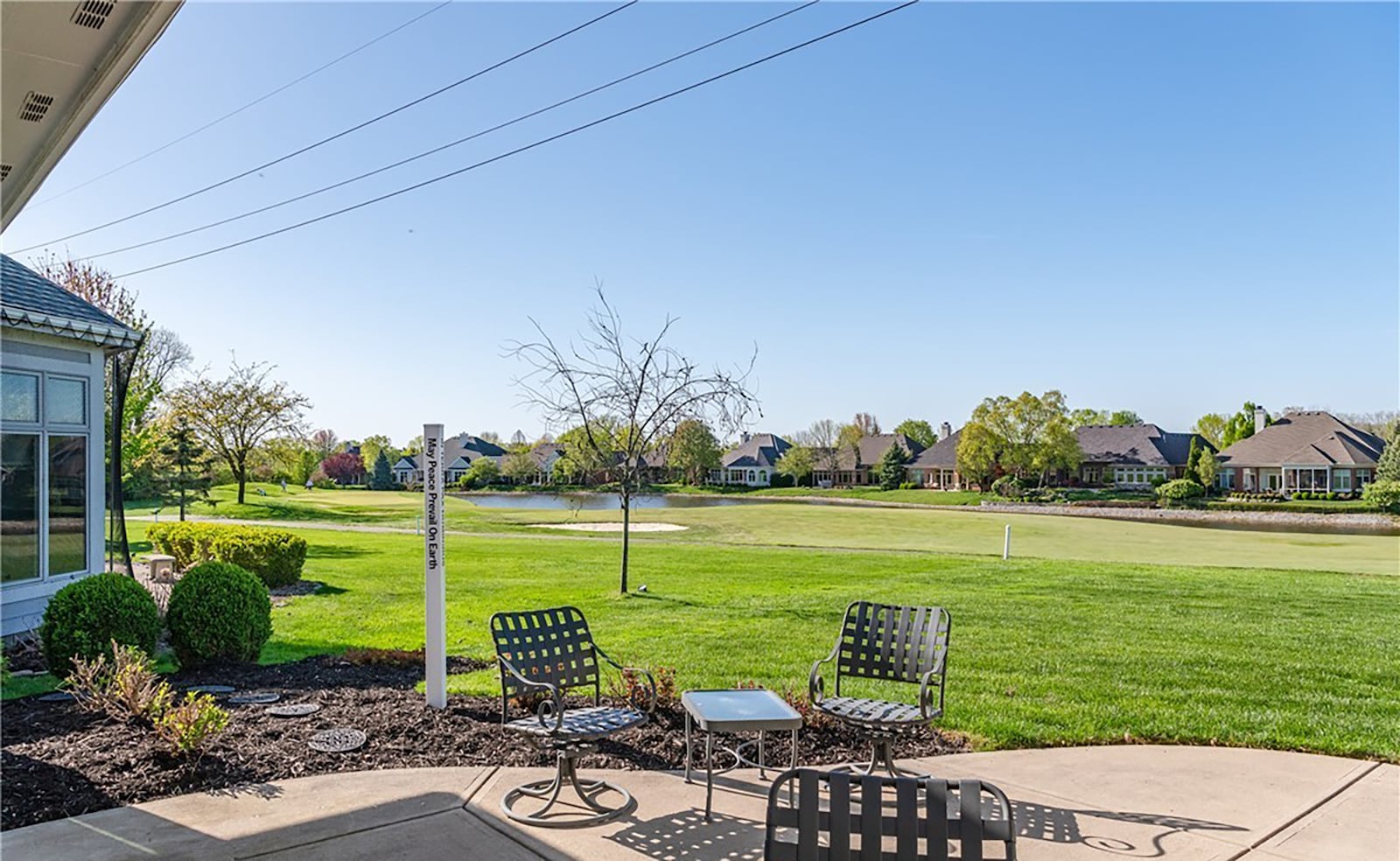 The rear patio has a view of the golf fairway and the lake beyond