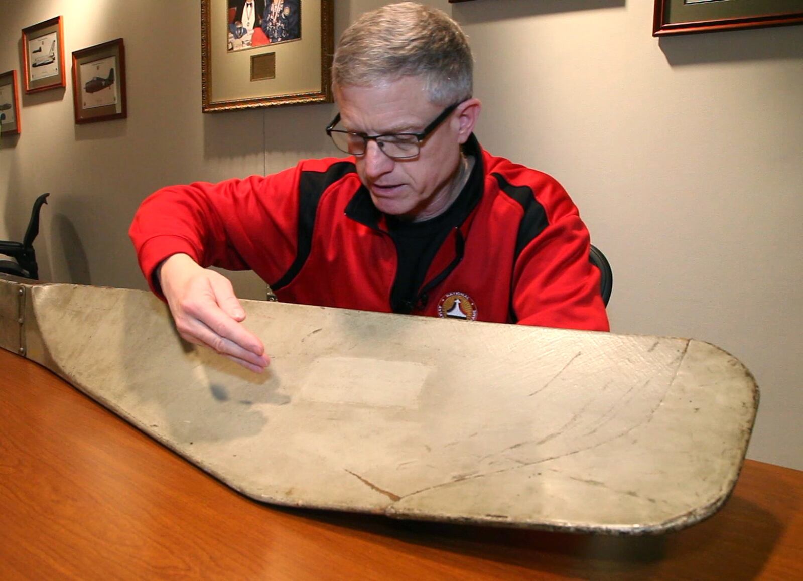 Ron Kaplan, Enshrinement and Outreach Director of the National Aviation Hall of Fame, points out the signature of Orville Wright on an original Wright propeller. The propeller, which is now owned by the NAHF, was given to a Wright Factory employee when the factory was closed in 1920. An NAHF trustee purchased the propeller at auction in 2004 and gifted it to the NAHF. TY GREENLEES / STAFF