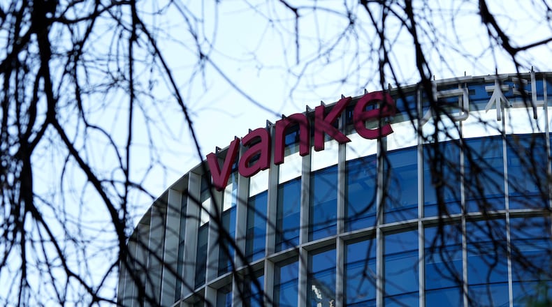 The Vanke logo is seen on a commercial complex in Beijing, China, Wednesday, Dec. 24, 2025. (AP Photo/Ng Han Guan)