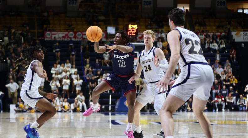 Dayton's Malachi Smith makes a pass against Chattanooga in the second round of the National Invitation Tournament on Saturday, March 22, 2025, at McKenzie Arena in Chattanooga, Tenn. David Jablonski/Staff