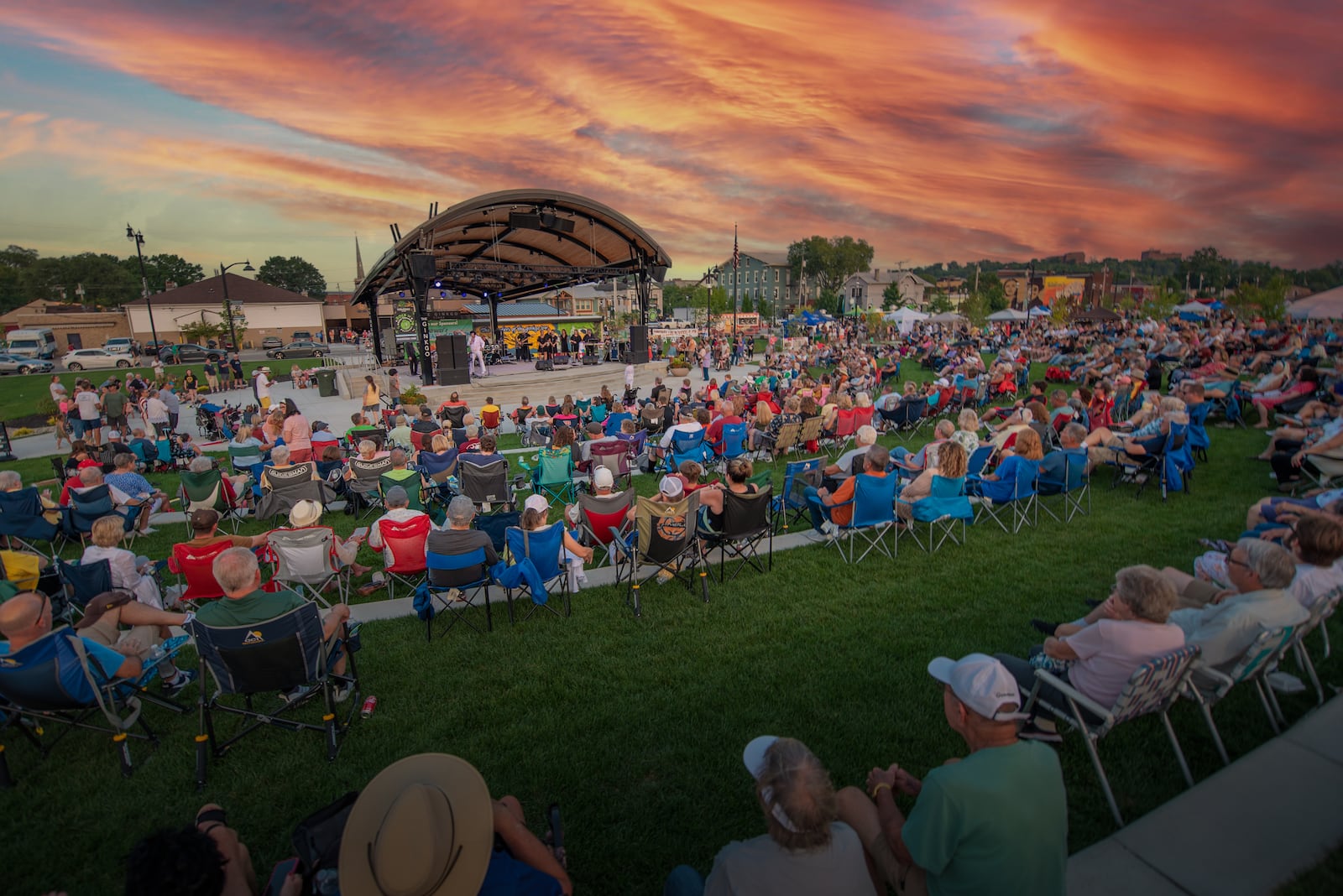 The crowd enjoys entertainment at the 2024 Rock ‘N’ Green Tomato Festival in Miamisburg's Riverfront Park. This year's event is scheduled to take there from 4:30 to 10:30 p.m. Aug. 1 and from 10 a.m. to 10 p.m. Aug. 2. CONTRIBUTED